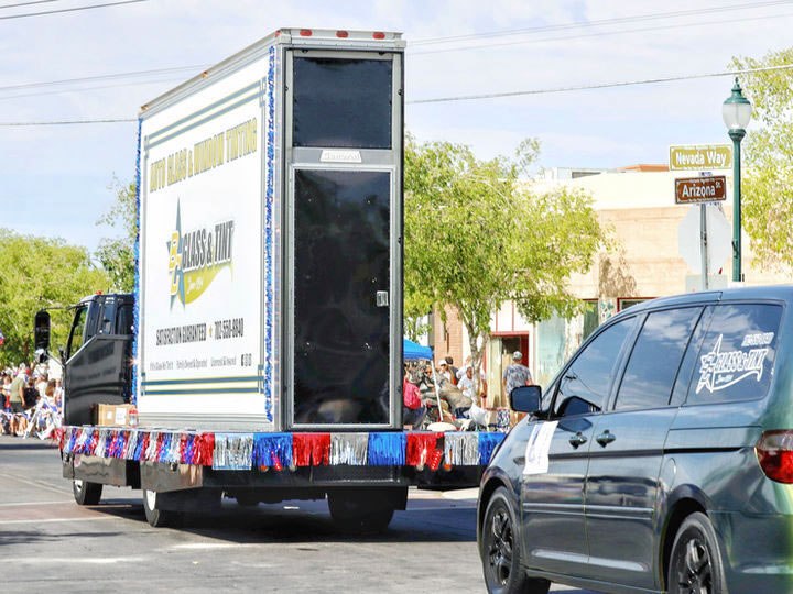 The shop's branded box truck in a street parade